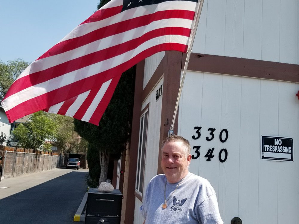 Homefront staff member near USA flag